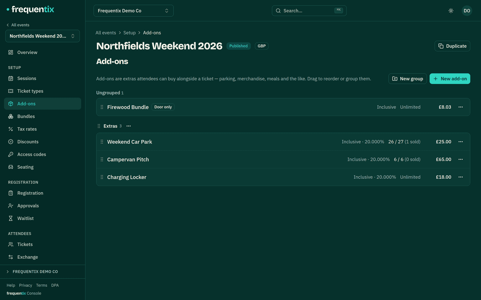 An event’s Add-ons list: an ungrouped “Firewood Bundle” marked Door only, then a named “Extras” group holding a weekend car park, a campervan pitch and a charging locker, each row with a drag handle, its tax treatment, remaining stock and price.