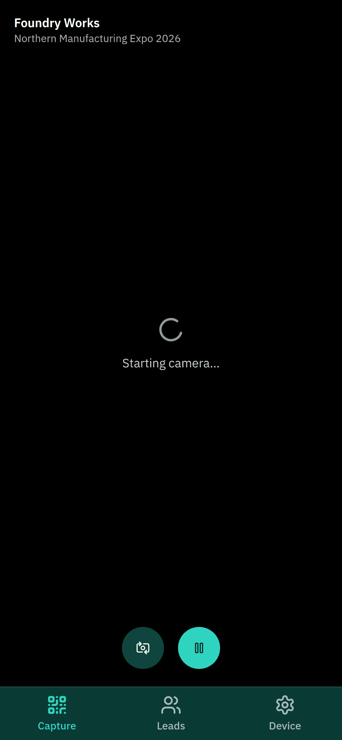 The capture screen: the stand and event named top-left, a Starting camera… spinner mid-frame, and round camera-flip and pause buttons above the bottom navigation.