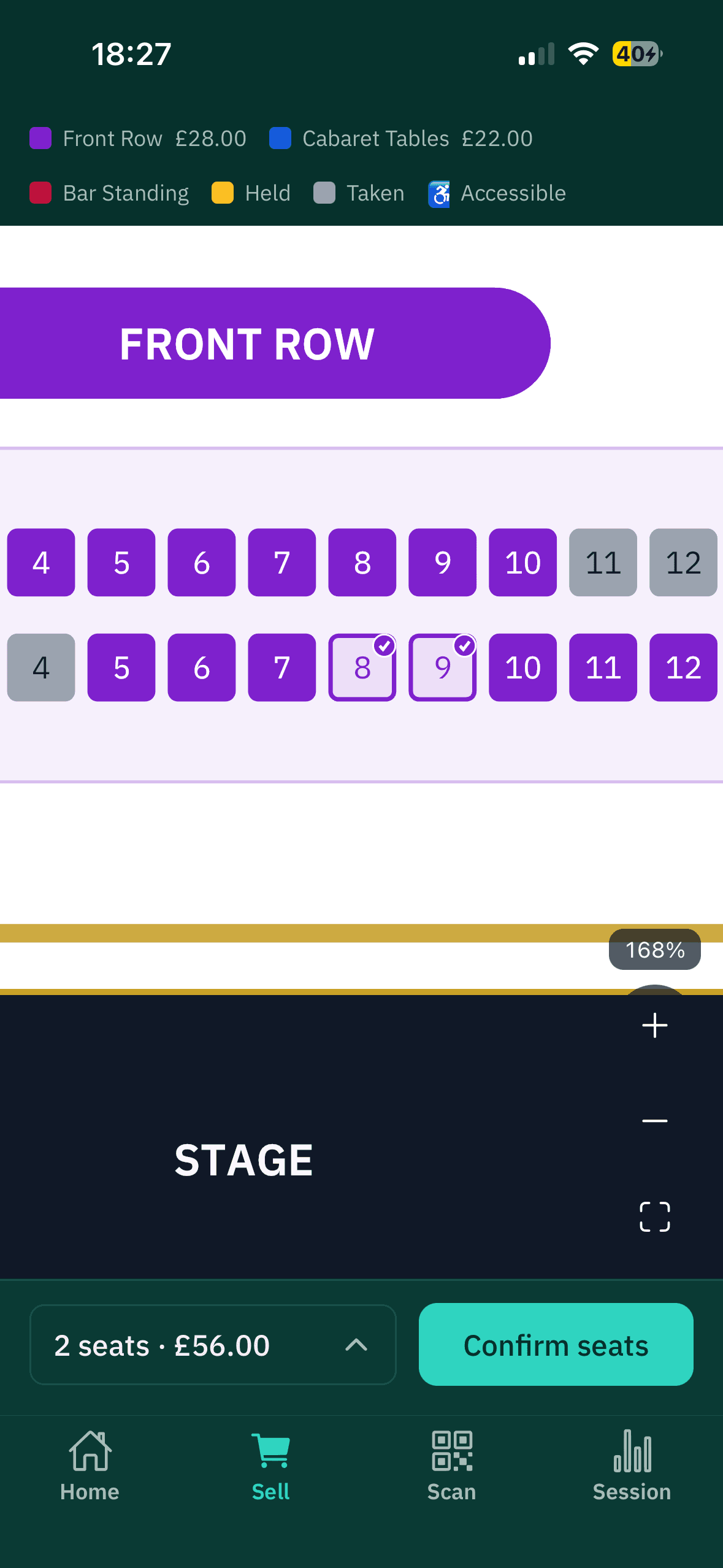 The seat picker zoomed to the front row, with two seats selected and priced, ready to confirm.